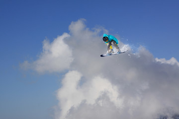 Obraz na płótnie Canvas Flying snowboarder on mountains. Extreme sport.