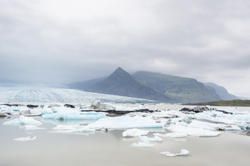 Glacial river lagoon.  Blue icebergs. Jokulsarlon glacier lake. Vatnajokull National Park. Iceland. August.