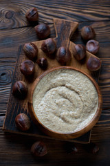 Top view of chestnut cream-soup in a rustic wooden setting