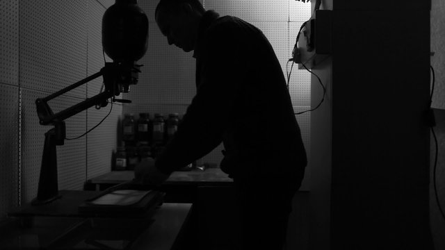Russia: novosibirsk: 25.09.2014 silhouette of a man working in the old darkroom
