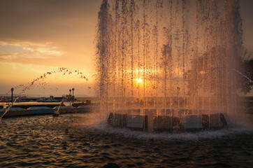 City fountain at sunset. Selective focus with shallow depth of field.