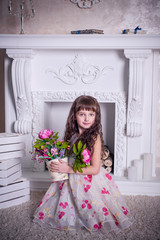 Studio photo cute girl near the fireplace