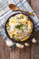 Cauliflower rice with scrambled eggs and herbs. vertical top view

