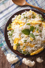 Paleo Food: Cauliflower rice with eggs closeup. vertical top view
