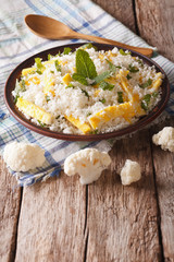 Dietary food: cauliflower rice with scrambled eggs. Vertical
