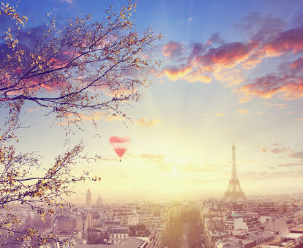 Aerial view of Paris cityscape with Eiffel tower at sunset with red balloon in form of heart Vintage colored picture Love and travel concept