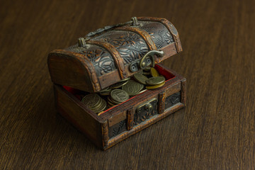 Treasure chest with old russian coin and have a wood floor in the background