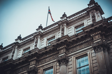 Fototapeta na wymiar Old classical building with waving flag