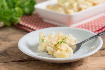 Macaroni and cheese in white plate.