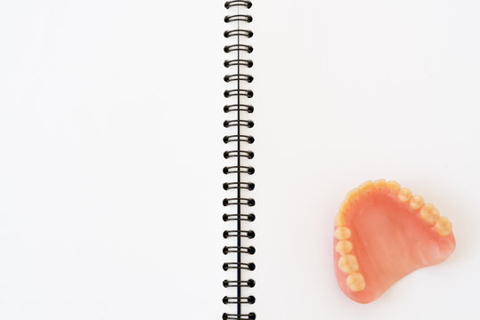 Denture on notebook background