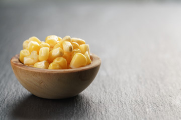 sweet canned corn in wood bowl on slate board