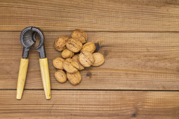 Nutcracker with nuts on wood