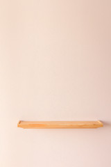 Empty wood shelf on pink wall