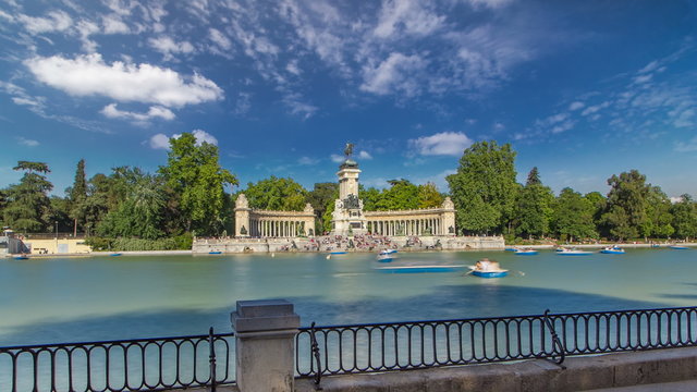 Tourists on boats at Monument to Alfonso XII timelapse hyperlapse in the Parque del Buen Retiro - Park of the Pleasant Retreat in Madrid, Spain