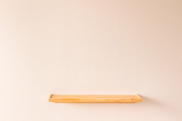 Empty wood shelf on pink wall
