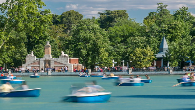 Tourists on boats at lake near Monument to Alfonso XII timelapse in the Parque del Buen Retiro - Park of the Pleasant Retreat in Madrid, Spain