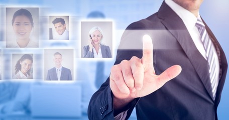Composite image of businessman pointing with his finger