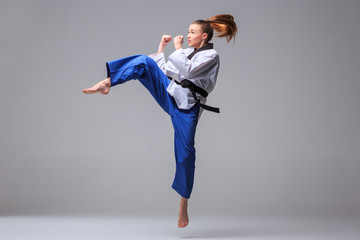 Studio shot of woman practicing karate