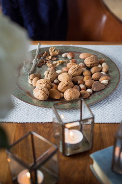 Assorted  nuts on vintage metal plate and vintage nutcracker. Selective focus.