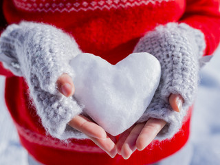 Snow heart on the hands of a girl