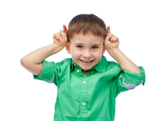 happy little boy having fun and making horns