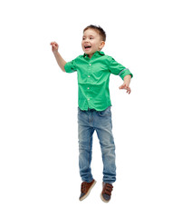 happy little boy jumping in air