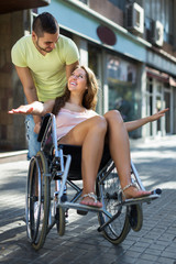 Husband taking spouse on wheelchair