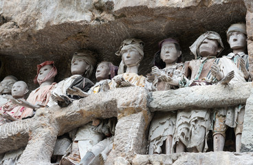 Wooden statues of Tau Tau. Suaya is cliffs old burial site in Tana Toraja. South Sulawesi, Indonesia