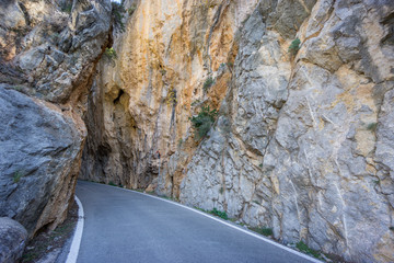 Curved road between rocks in the mountain, wild track