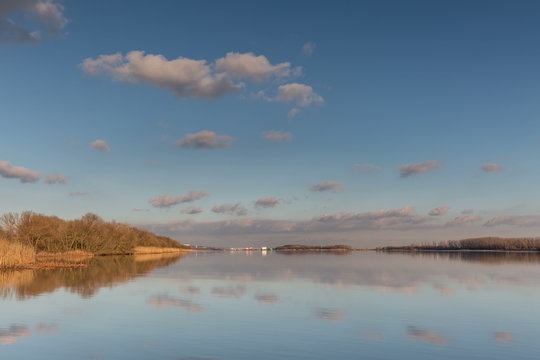 Time lapse. Russia, Rostov region. Moving clouds and their reflection in the river Don.