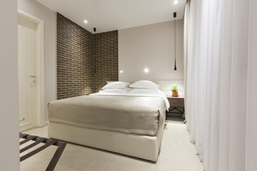 Fototapeta na wymiar Modern bedroom interior in the evening