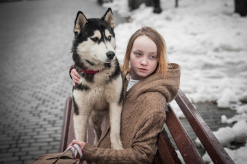 A teen girl with husky dog