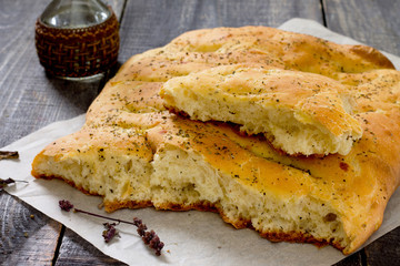 Italian focaccia bread with cheese and onions on a wooden table