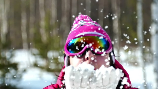 A woman enjoys snow during the winter, Slow Motion Video clip