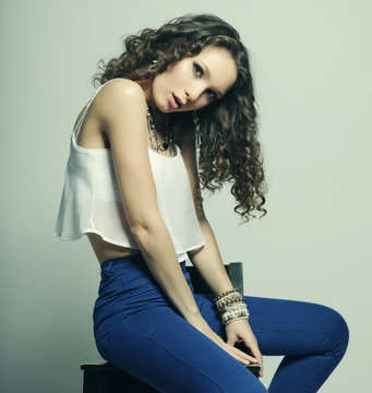 Young Fashion Model Sitting On Chair