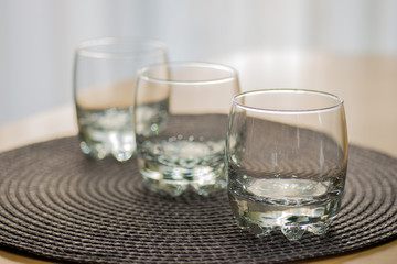 Three empty juice glasses on the table