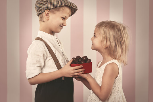 Boy Giving A Girl Box Full Of Chocolates