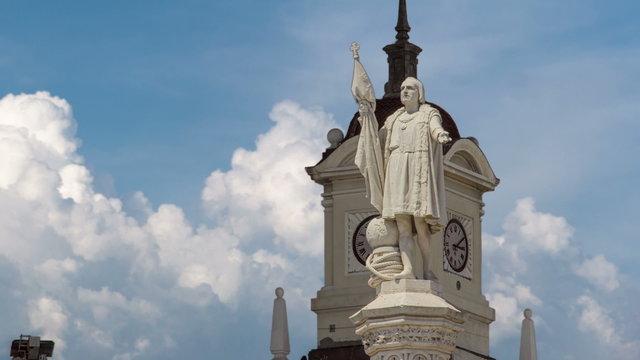 Monument to explorer Christopher Columbus and tower with watch on the Columbus square timelapse hyperlapse.
