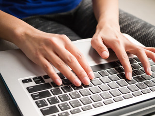 Close up of a woman hands working with a laptop