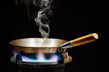 chinese wok pan on fire gas burner © nikkytok