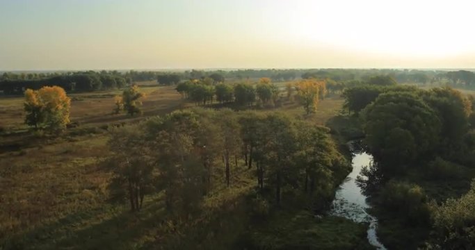 Panoramic Autumn landscape. The picturesque landscape with river, trees and field.