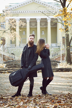 Fashion portrait of young couple in autumn park outdoor, image t
