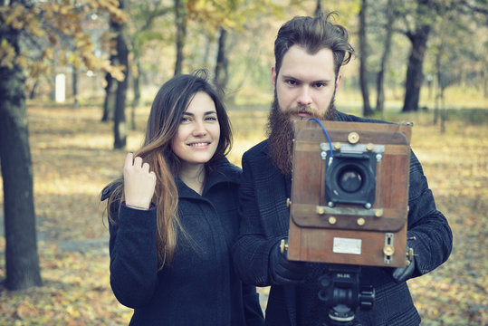 Photographer hipster takes photo with retro camera outdoor, imag