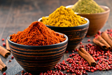 Variety of spices on kitchen table - obrazy, fototapety, plakaty