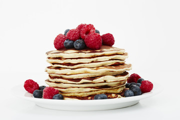 Fresh pancakes topped with fruit, studio shot