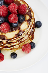Pancakes topped with fruit and ready to eat, close up
