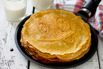 Stack of pancakes from oat flour and milk in a rustic style