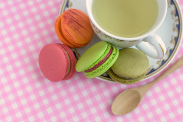 Cup of tea with colorful macaroons