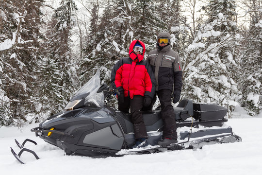Man and woman on a snowmobile.