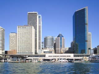 Fototapeta na wymiar Sydney ferry terminal, Circular Quay, with the downtown cityscape as a backdrop.
